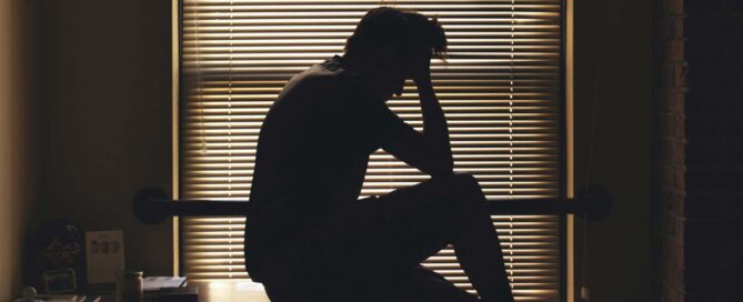 man in office looking to struggle with mental health