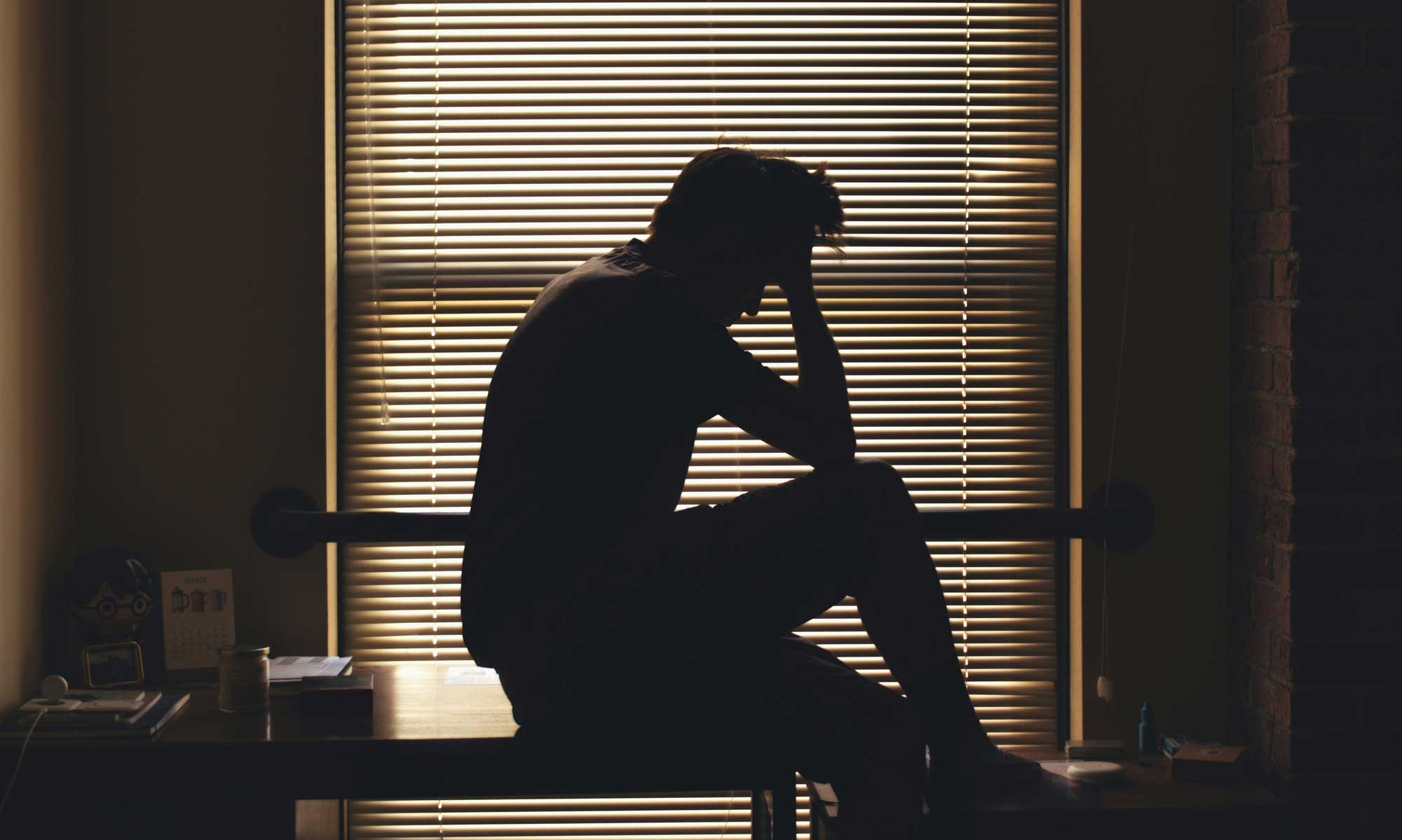 man in office looking to struggle with mental health