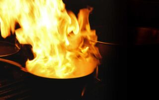 Kitchen fire in pan on stove.