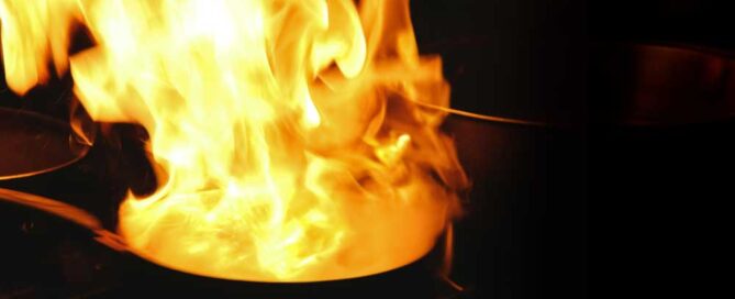 Kitchen fire in pan on stove.