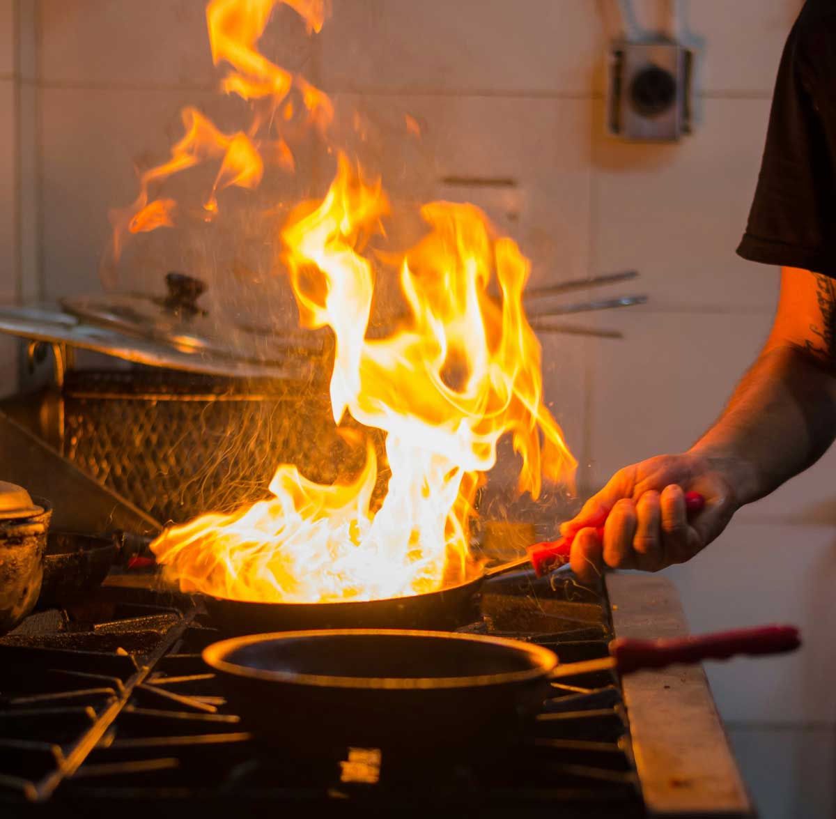 flames in frying pan on stove.