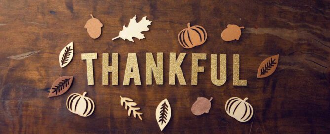 fall scene with letters spelling the word thankful